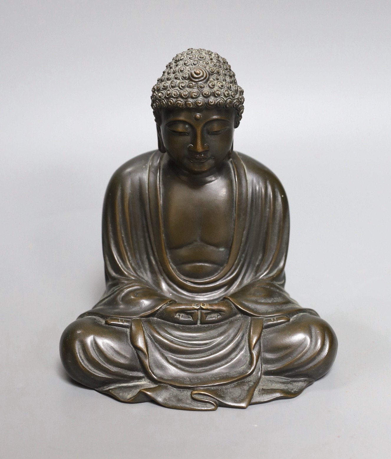 An early 20th century Japanese bronze figure of a seated Buddha, signed, 17cm